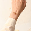 Load image into Gallery viewer, A model wearing an angel number 777 bracelet on her left wrist
