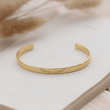 Load image into Gallery viewer, Personalized Angel Wing Memorial Gold Plated Bracelet on top of an open book
