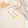 Load image into Gallery viewer, 555 angel number pendant gold necklace laid out
