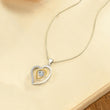 Load image into Gallery viewer, Work Bestie Luxe Heart Necklace on a page of an open notebook
