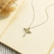 Load image into Gallery viewer, To My Soulmate Cross and Heart Necklace placed on the top of a book page  with dried flowers
