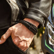 Load image into Gallery viewer, Leather cross bracelet for him, with message &quot;love you forever&quot; being worn by a model with a leather jacket
