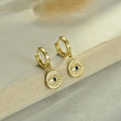 Load image into Gallery viewer, Blue Evil Eye Medallion Earrings hanging on a book page
