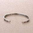Load image into Gallery viewer, We Are Best Friends Because Everyone Else Sucks printed in a silver plated cuff bracelet placed on top a brown fabric
