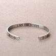 Load image into Gallery viewer, &quot;I am the storm&quot; bracelet placed on top of a piece of cloth

