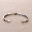 Load image into Gallery viewer, Memorial bracelet with engraved message &quot;A piece of my heart lives in heaven&quot; placed on top of brown fabric
