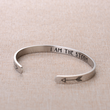Load image into Gallery viewer, &quot;I am the storm&quot; bracelet placed on top of a piece of cloth in different angle
