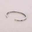 Load image into Gallery viewer, silver plated bracelet A Sister Is God&#39;s Way of Making Sure We Never Walk Alone on top of a cloth

