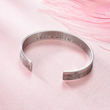 Load image into Gallery viewer, Motivational message engraved in a silver bracelet for best friend placed on top of a pink cloth
