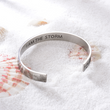 Load image into Gallery viewer, &quot;I am the storm&quot; silver cuff bracelet placed on top of sea shells
