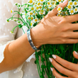 Load image into Gallery viewer, A model holding flowers wearing Promise To Love You cuff bracelet
