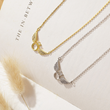 Load image into Gallery viewer, Angel Wings Memorial Necklaces on an open book
