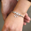 Load image into Gallery viewer, Model wearing Dreamcatcher memorial bracelet
