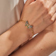 Load image into Gallery viewer, Multicolored butterfly gold chain bracelet being worn by a model on her right wrist
