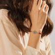 Load image into Gallery viewer, A model wearing Multicolored Charm Blue Evil Eye Red String Bracelet
