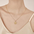 Load image into Gallery viewer, A model wearing Round Evil Eye Gold Tone Necklace
