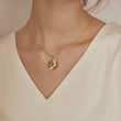Load image into Gallery viewer, A model wearing Pleated Medallion Evil Eye Necklace
