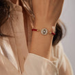 Load image into Gallery viewer, A model wearing a black evil eye red string bracelet
