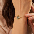 Load image into Gallery viewer, A model wearing a round illusion evil eye gold bracelet
