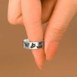 Load image into Gallery viewer, Memorial silver plated ring with butterfly print being held by a model
