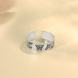 Load image into Gallery viewer, Memorial silver plated ring with butterfly print placed on top of a piece of paper

