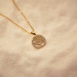 Load image into Gallery viewer, Round Tree of Life Crystal and Pearl Gold Necklace placed on top of a cotton fabric sheet
