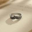 Load image into Gallery viewer, silver Until We Meet Again Personalized Angel Wing Ring with Carol engraving on a page on an open book
