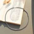 Load image into Gallery viewer, silver Link Chain Necklace on an open book
