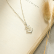 Load image into Gallery viewer, Friendship Anchor Necklace on a page of an open book
