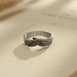 Load image into Gallery viewer, Angel Number Wing Ring with 111 engraving on a page of an open book
