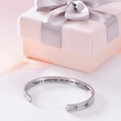 Load image into Gallery viewer, Silver bangle bracelet with a printed message &quot;God Is Within Her - Psalm 46:5&quot; placed on top of a piece of paper together with a gift box
