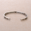 Load image into Gallery viewer, Inspirational message engraved on a silver cuff bracelet placed on top of a piece of cloth
