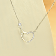 Load image into Gallery viewer, A close-up shot of Infinite Heart Necklace place on the first page of the book
