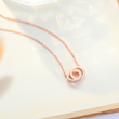 Load image into Gallery viewer, To My Daughter Forever Linked Together Round Interlocking Necklace placed on the top of a book
