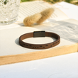 Load image into Gallery viewer, To My Son, I Love You Leather Morse Code Bracelet placed on top of an open book
