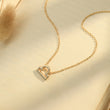 Load image into Gallery viewer, Libra zodiac sign necklace placed on top of a brown paper
