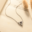 Load image into Gallery viewer, To My Wife, Triangle Projection Necklace laid down on top of a page of a book
