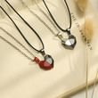Load image into Gallery viewer, Magnetic Heart Couple Necklace Placed on the top of a Book
