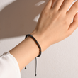Load image into Gallery viewer, A female model wearing a Memorial morse code bracelet with &quot;Until we meet again message&quot;
