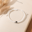 Load image into Gallery viewer, Photo Projection Memorial Bracelet on an open book
