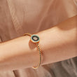 Load image into Gallery viewer, A model wearing a Round Illusion Evil Eye Beaded Bangle
