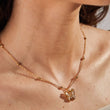 Load image into Gallery viewer, White Stone Butterfly Necklace Gold worn by a female model
