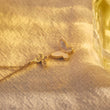 Load image into Gallery viewer, Duo Butterfly Gold Chain Necklace placed on top of a white piece of cloth
