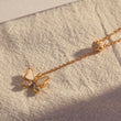 Load image into Gallery viewer, White Butterfly Necklace Long Chain gold plated Pendant placed on top of a white fabric
