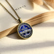 Load image into Gallery viewer, To My Son, Love Dad Pendant Necklace on a page of an open book
