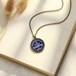 Load image into Gallery viewer, To My Son, Love Dad Pendant Necklace on a page of an open book
