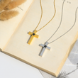 Load image into Gallery viewer, Personalized Memorial Cross Projection Necklace placed on the top of a book
